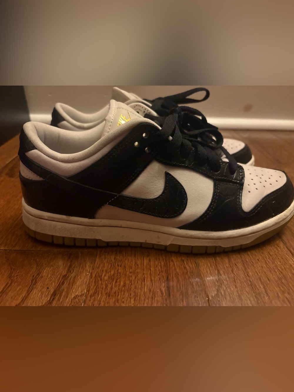 Nike Black and White Dunk Low Sneakers with Gold Tongue Detail